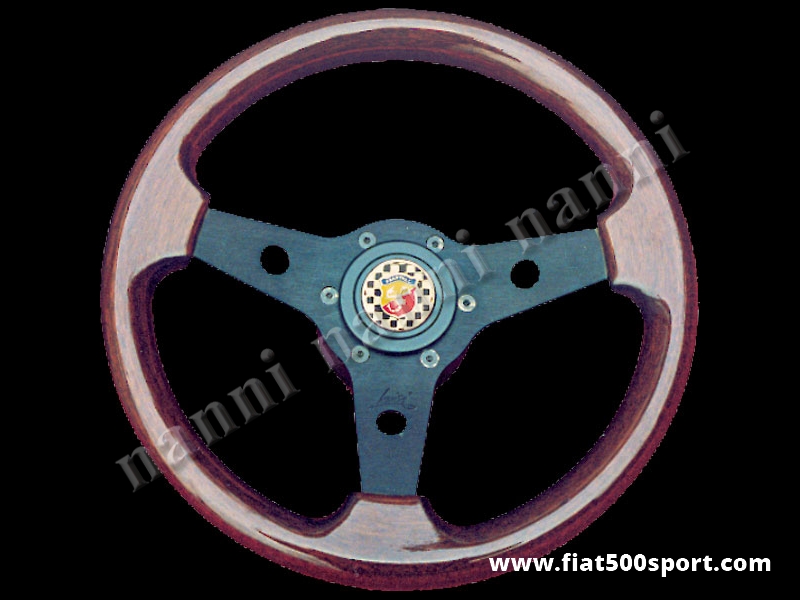 Art. 0016 - Volante Fiat 500 Fiat 126 Abarth in mogano a calice con razze nere completo di mozzo e pulsante clacson Abarth. - Volante FIAT 500 Fiat 126 Abarth in legno di mogano a calice con razze nere, completo di mozzo per Fiat 500 e pulsante clacson Abarth. (specificare nelle note se lo si desidera con mozzo per Fiat 126). Il diametro esterno è di 315 mm.
